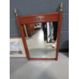 A rectangular mirror in teak frame