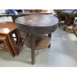 A circular dark oak 2 tier table