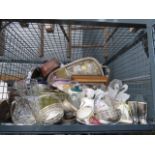 A cage containing a large quantity of glassware, crockery and a silver plated tray