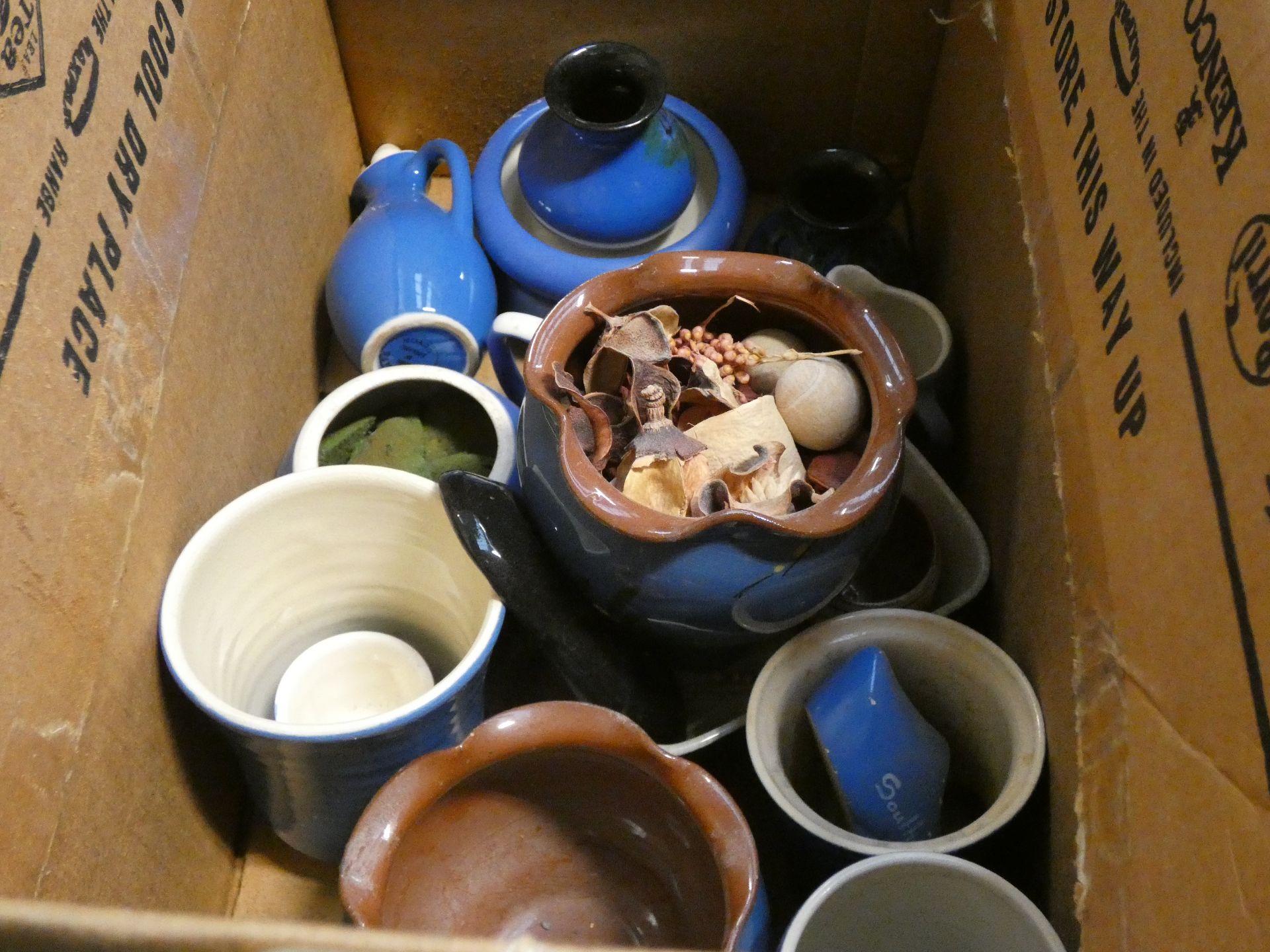 A box containing blue glazed Devon pottery