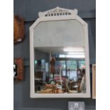 A mirror in white painted frame
