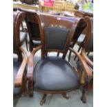 A brown leather swivel office armchair