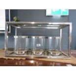 A chromed stand with 4 candle holders
