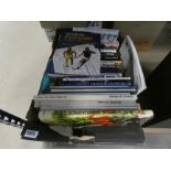 A box containing a quantity of football and football reference books and cookery books