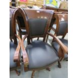 A brown leather swivel office armchair