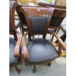 A brown leather swivel office armchair