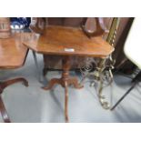 A Victorian tripod tilting side table