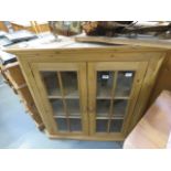 Pine and glazed double door corner cupboard