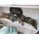 A shelf with horse brasses, trivets and general metalware