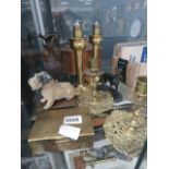 A cage containing brass candlesticks, ornamental dogs, pots and vase