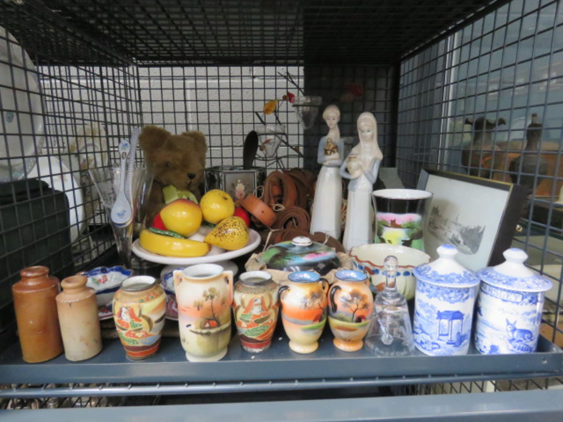 A cage containing a pair of Nao style figures, miniature Oriental pots and vases, blue & white