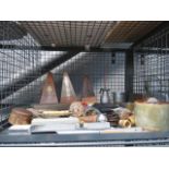 A cage containing metronomes, spirit levels, metalware and ornaments