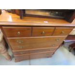 A cherry finished chest of 5 drawers