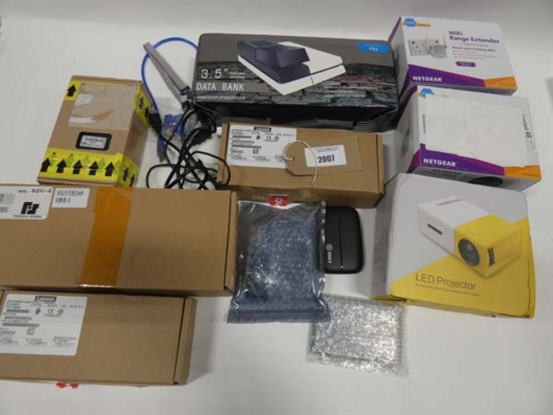 Bag containing LED projector, Netgear WiFi range extenders, power supplies, 3.5 data bank for PS4,