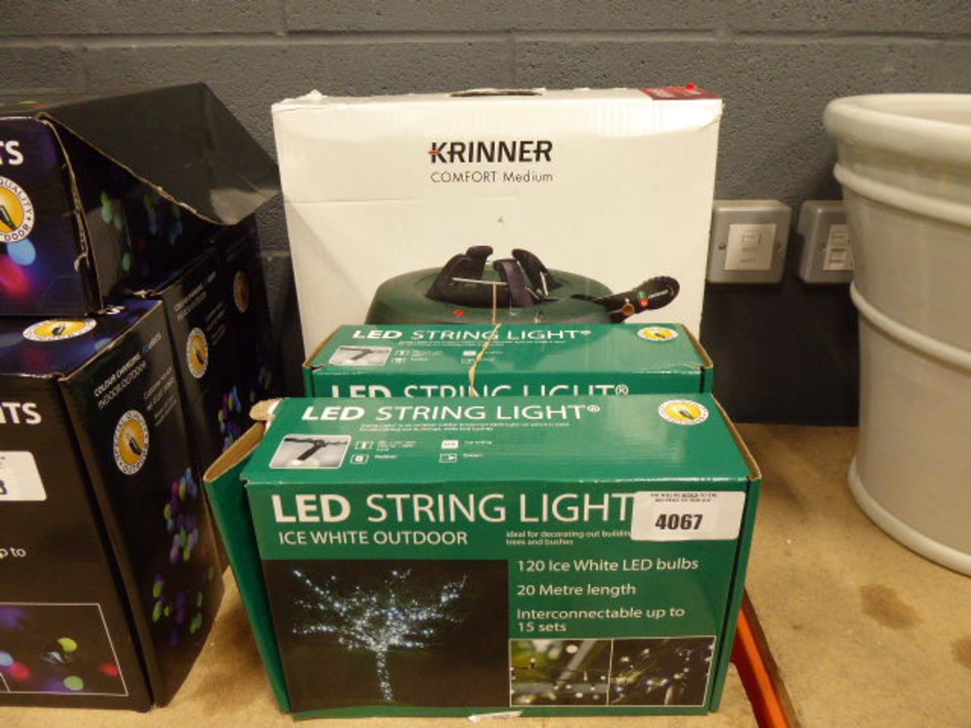 2 small green boxes of lED string lights and Christmas tree stand