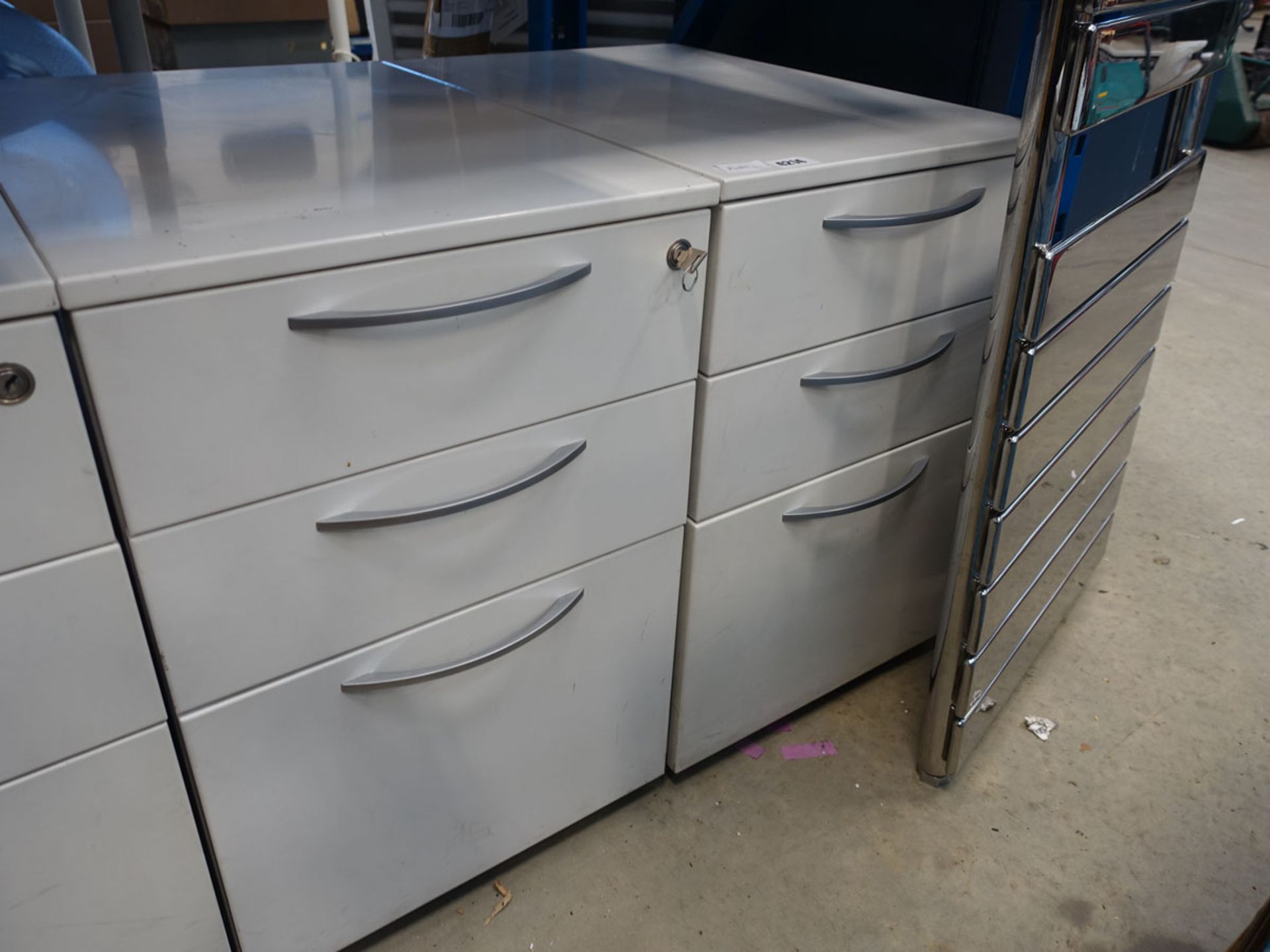 Two white three drawer metal pedestals