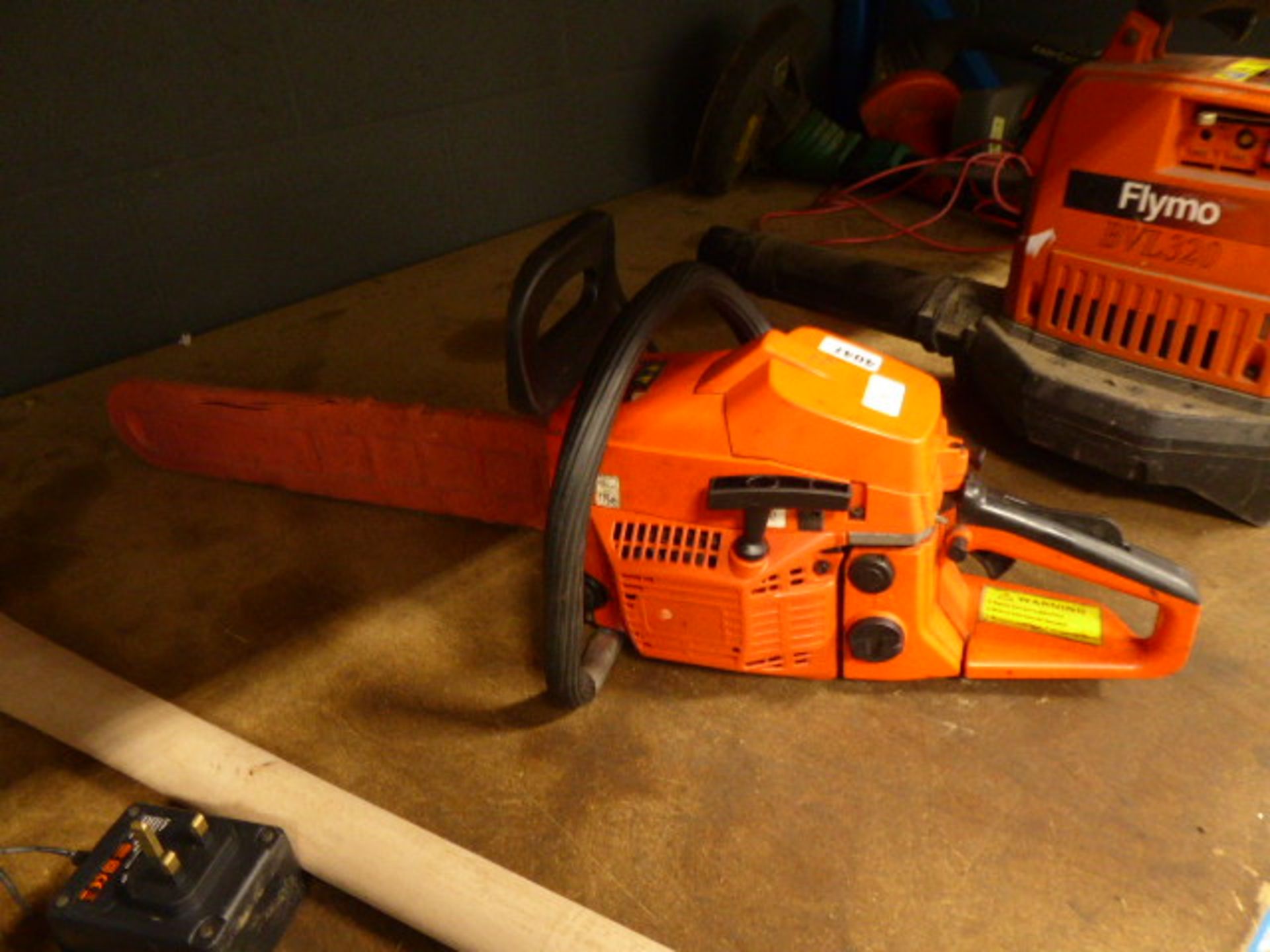 Orange petrol powered chainsaw