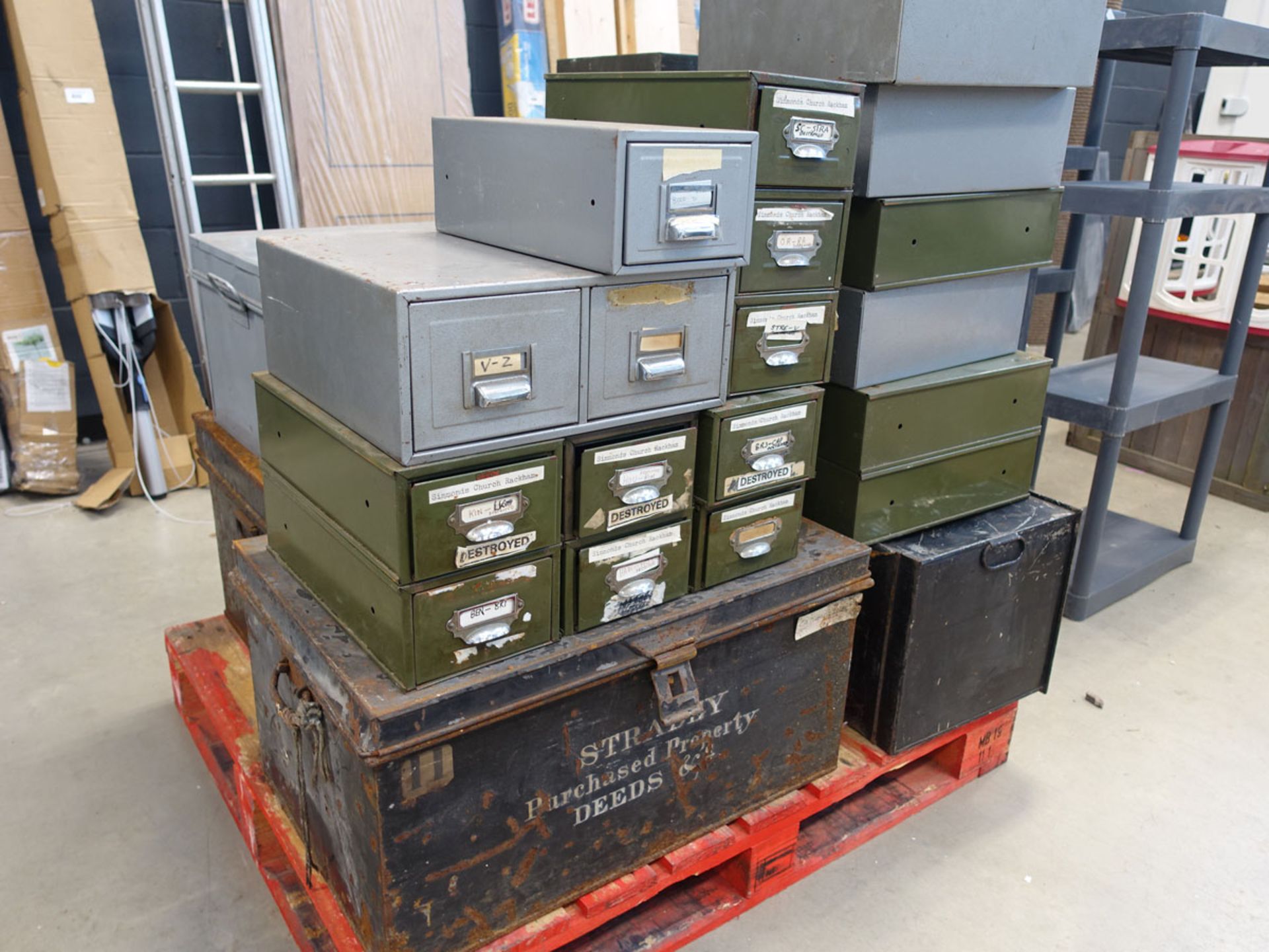 Pallet of green and grey vintage index card boxes and metal trunks