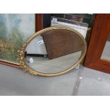 Oval bevelled mirror in gilt frame