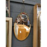 Oval bevelled mirror with floral decoration