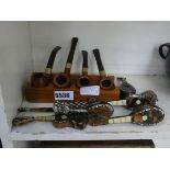 (6) Pipe rack with pipes and a quantity of miniature mandolins