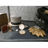 Cage containing a bowler hat, silhouette, figure, portrait, plus buttons and a clock