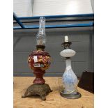 2 floral decorated oil lamps