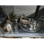 Cage containing a quantity of stainless steel tea pots, dishes, and post rack