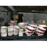 Cage containing a decanter, plus a quantity of Park Lane Staffordshire crockery