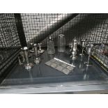 Cage containing silver plated candle sticks and coinage