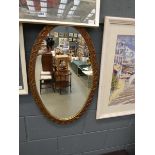 Oval mirror with gold filigree design