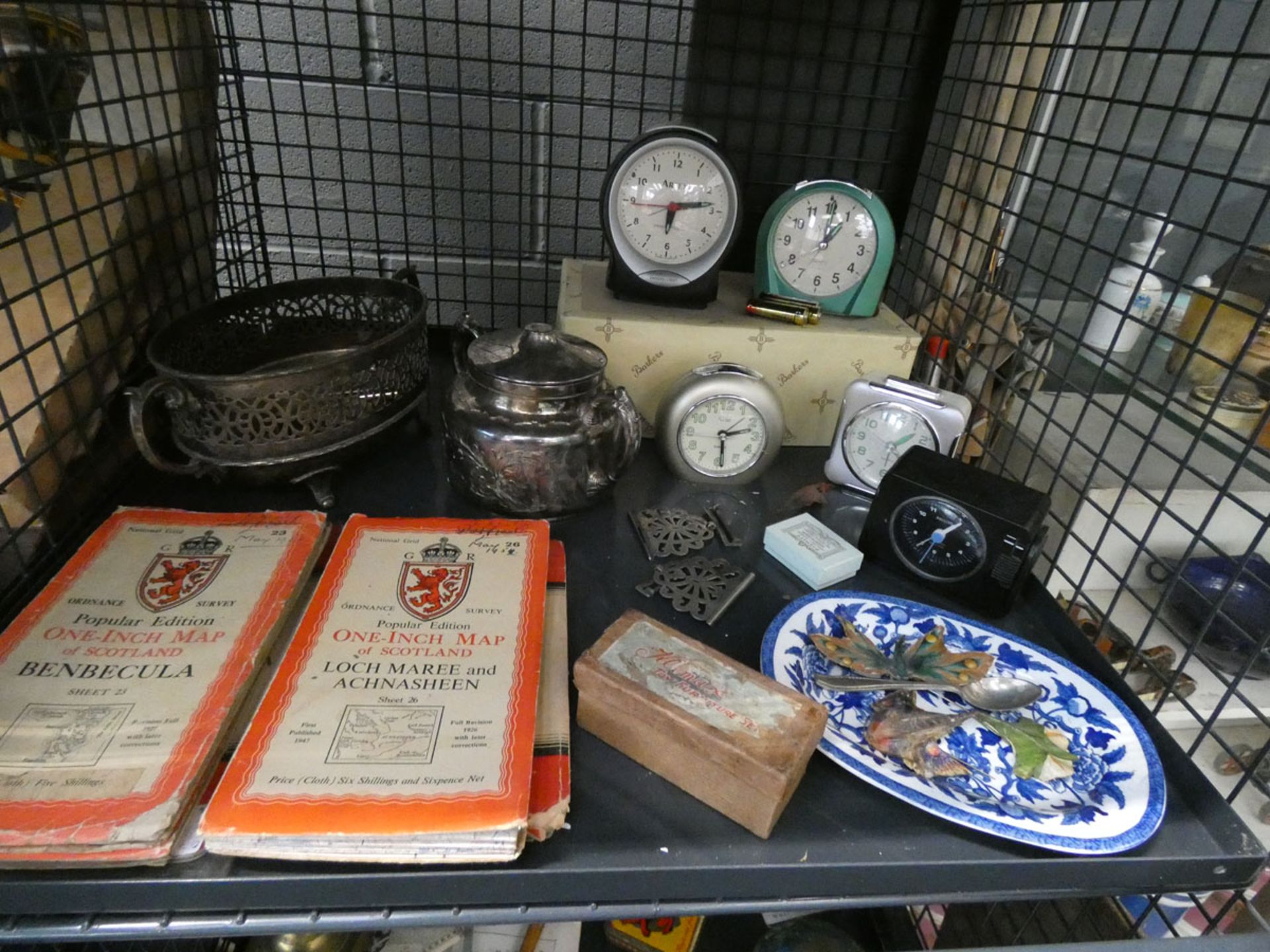 Cage containing quartz alarm clocks, silver plate and ordnance survey maps
