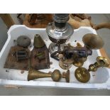 Box of electric doorbells, oil lamp, brass vases, heat gun and a candlestick