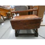 Teak two tier tea trolley and an oak dropside table