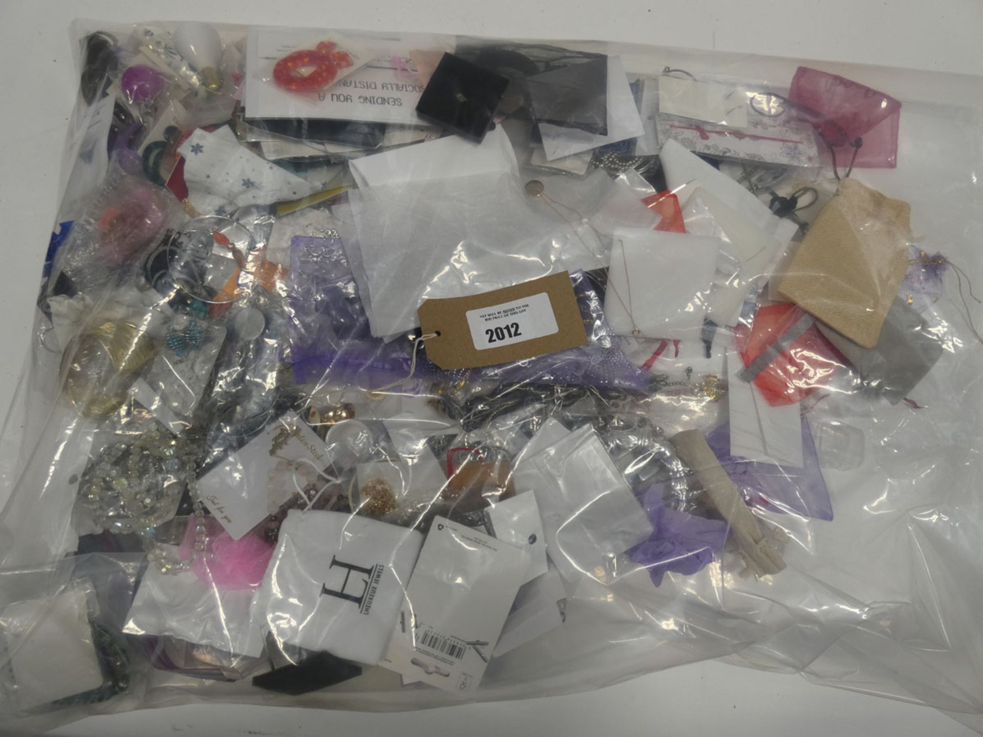 Bag containing quantity of loose costume and dress jewellery