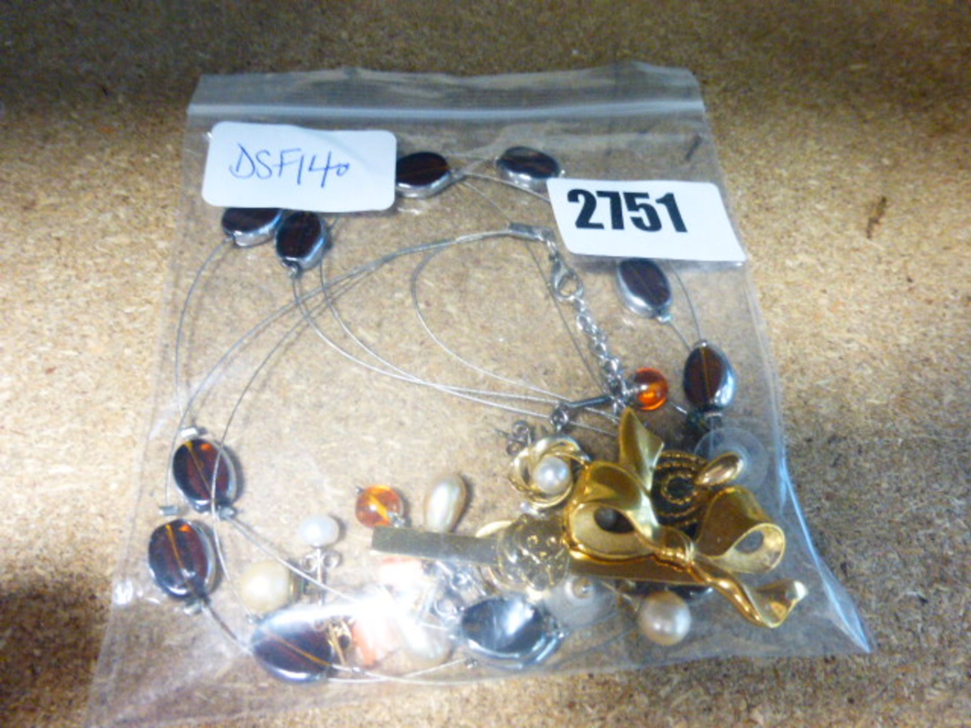 Selection of costume jewellery items in clear bag
