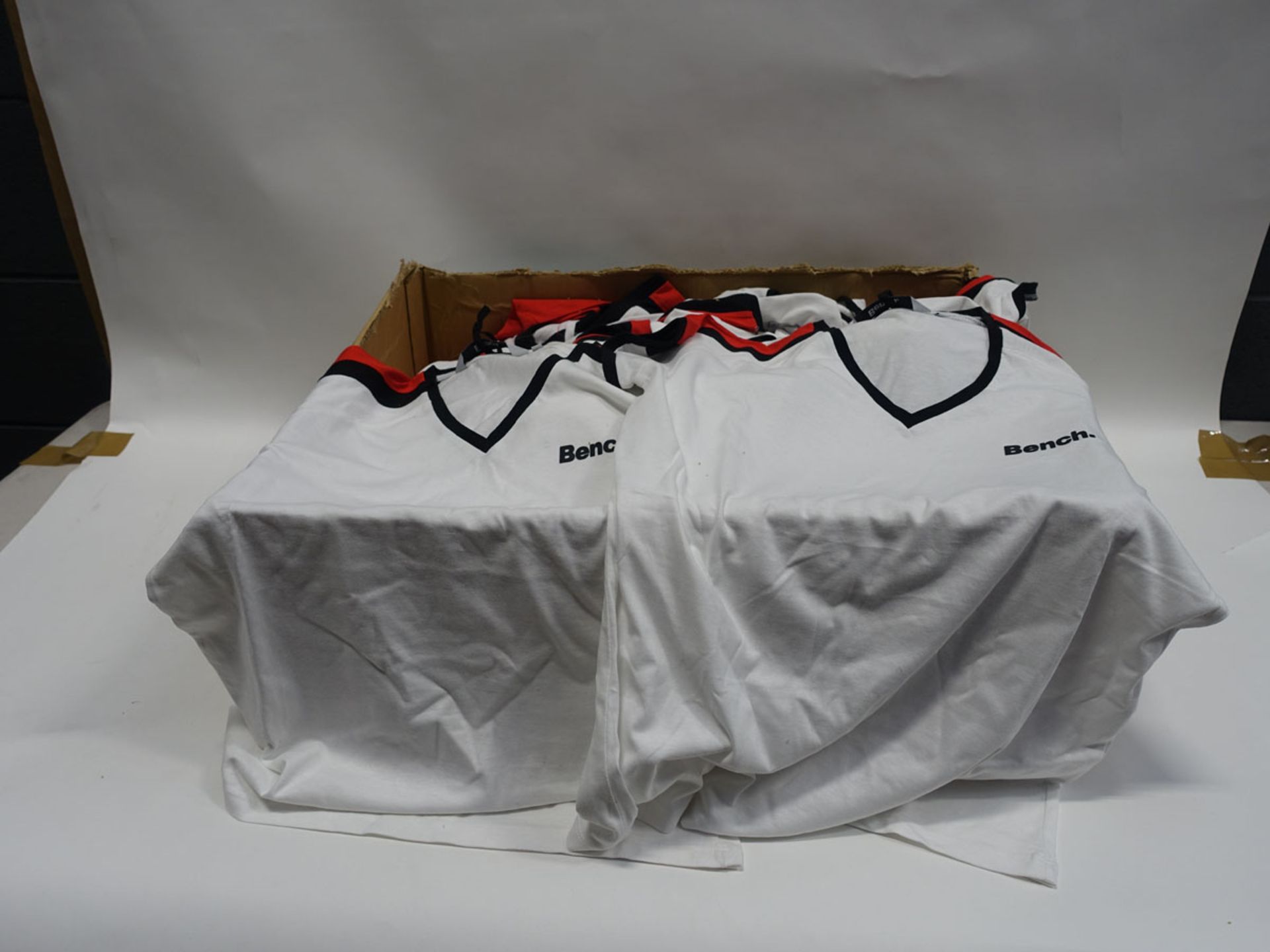 Box containing 70 Bench white v-neck t-shirts with black and red trim