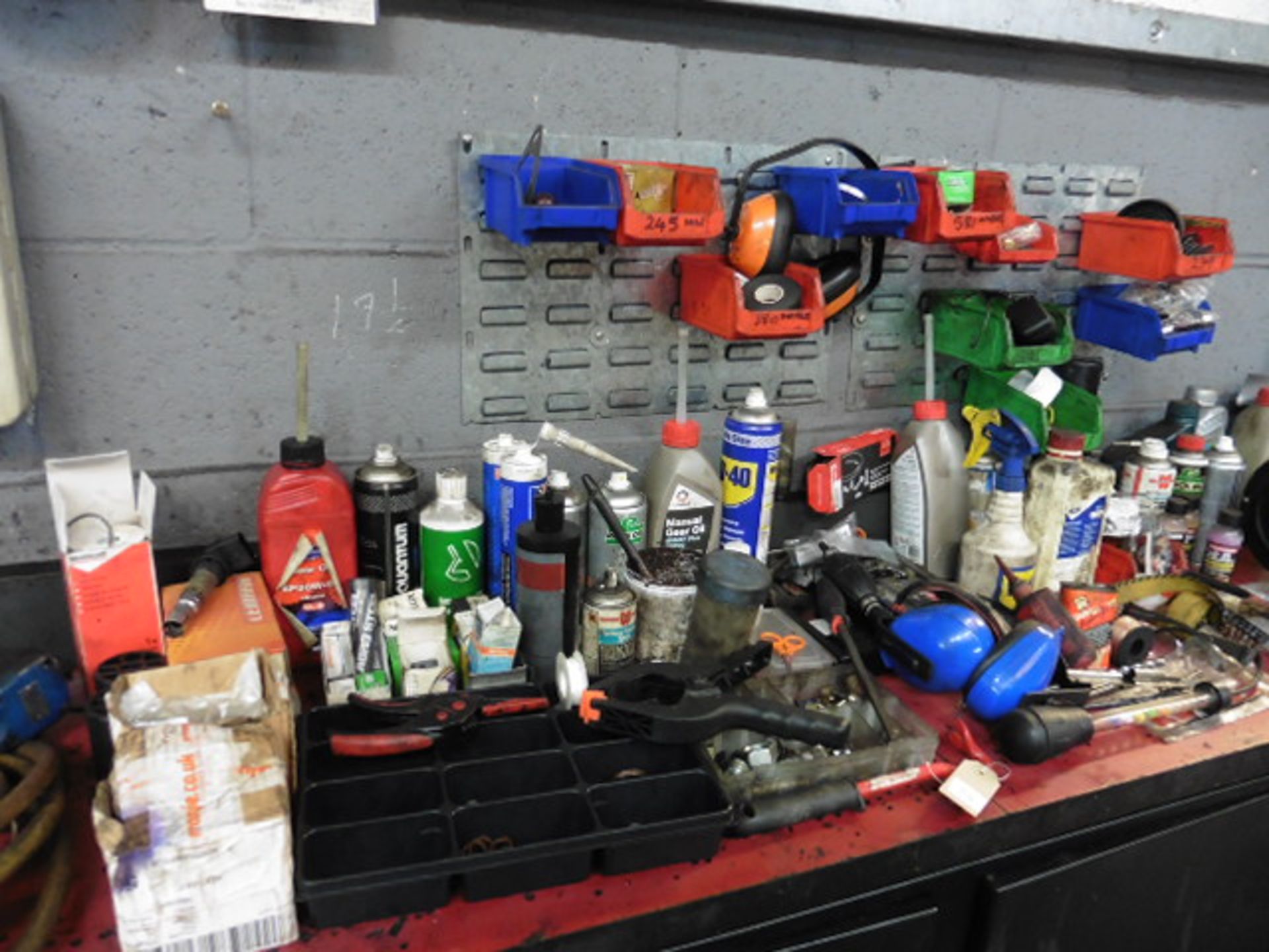 The remaining loose items on the work bench including parts, bulbs, washers ,lubricants, lin bins,