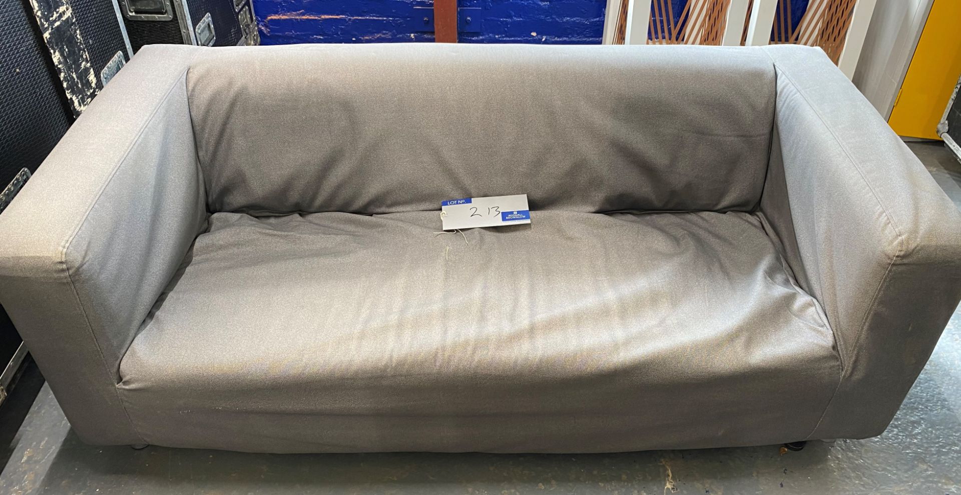 A 2 seat Settee in grey fabric (located at 17 Deer Park Road, London, SW19 3QG).