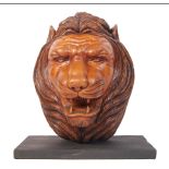 Large carved wooden lions head on black marble base