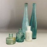 A group of 5 antique light green glass bottles