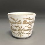 An Antique porcelain cup - named MARGARETTA MARY JONES Born February 20th 1903