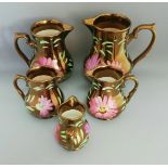 A Set of 5 Vintage Wade Hand Painted Pink Purple Floral Copper Lustre Jugs