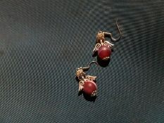 Earrings with purple stone