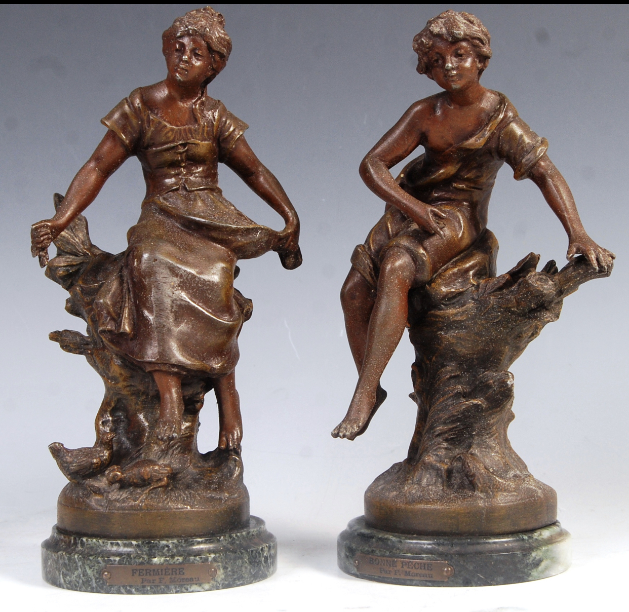 Pair of painted bronzed spelter figures entitled fermiere and bonne peche