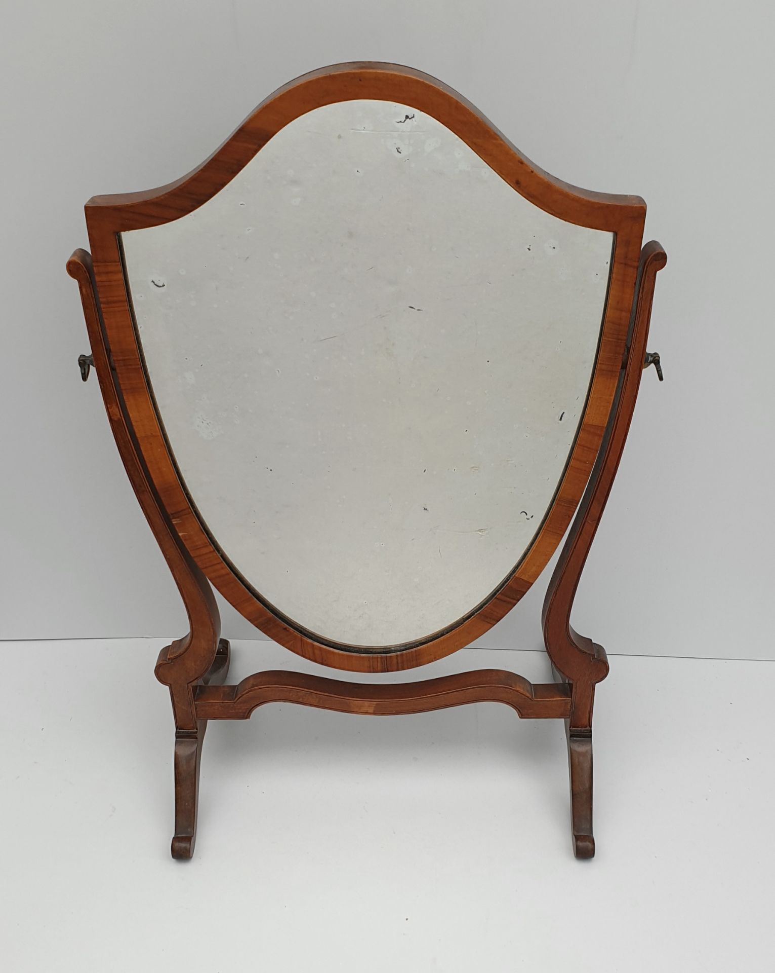 Edwardian Hardwood Mirror Shield Shape Measures 14 inches by 23 inches tall.