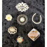 Group of vintage brooches, various materials.