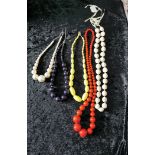 Group of large vintage style brightly coloured knecklaces.