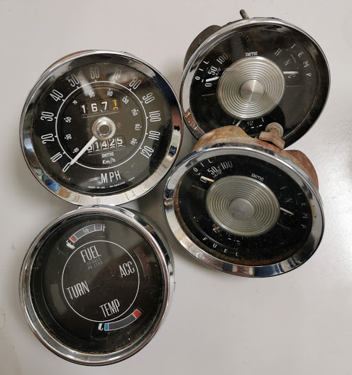 Group of four classic car Smiths guages including speedometer.