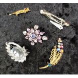 Group of vintage costume brooches, various materials.